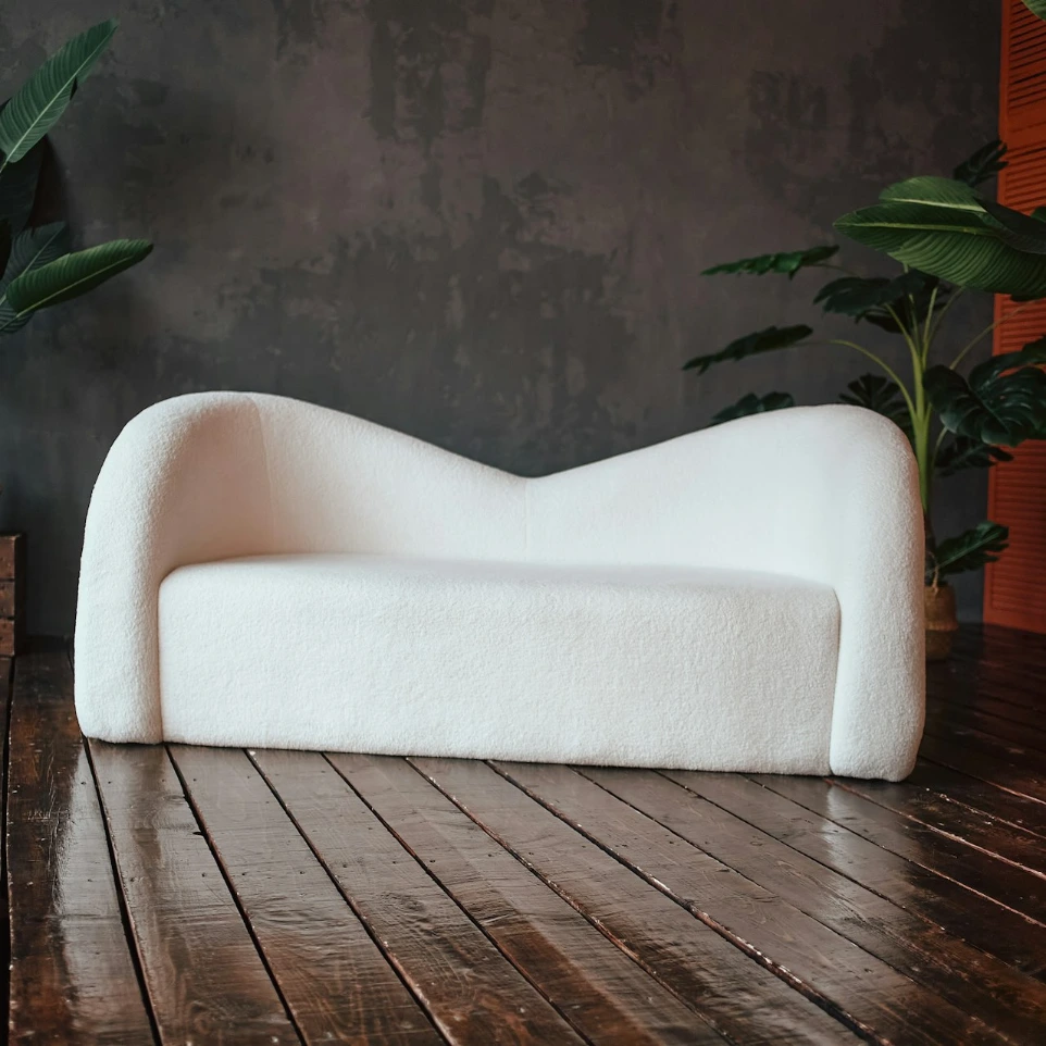 A white couch sitting on top of a wooden floor